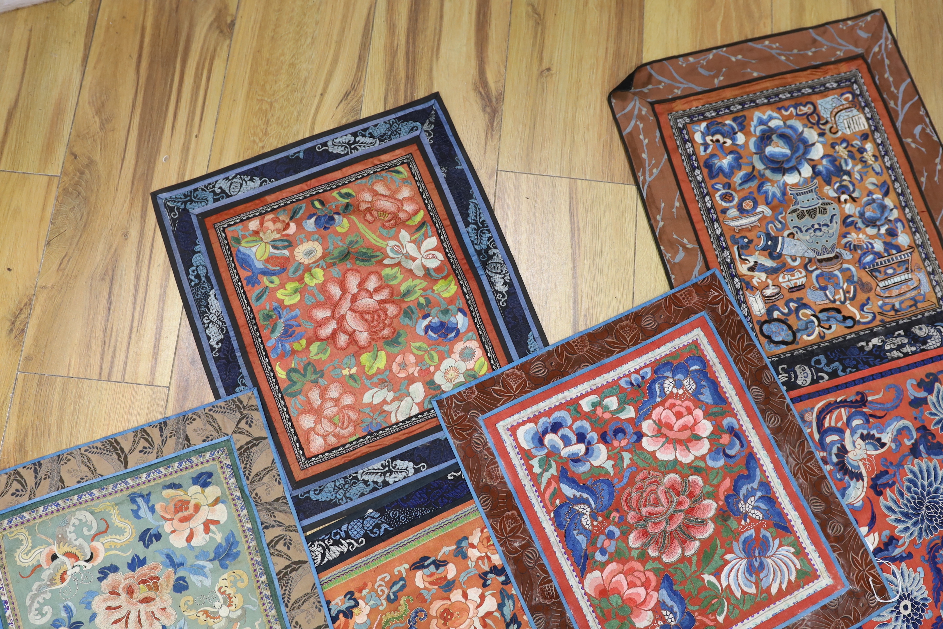 Six panels of Chinese silk embroidered mats, all using mixed stitches including Beijing knot, all bordered with silk brocade